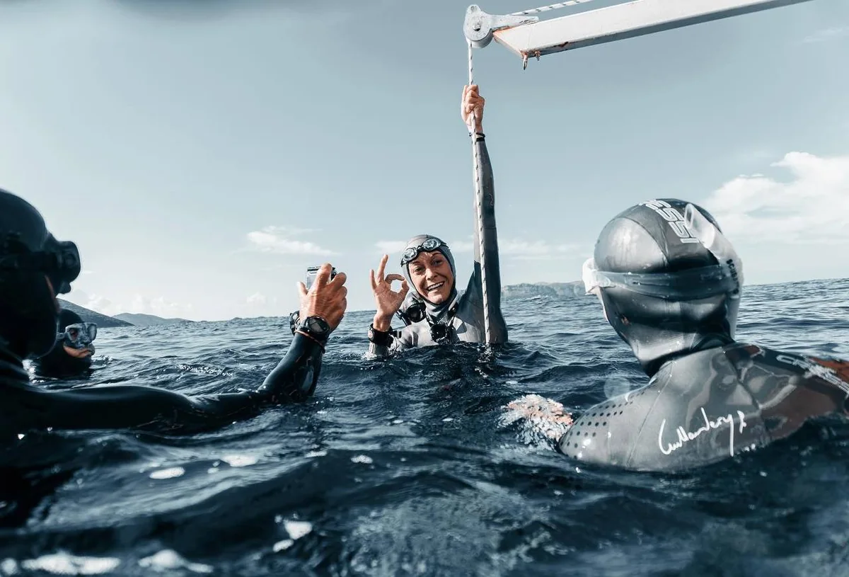 Freediving team discussing training at the surface