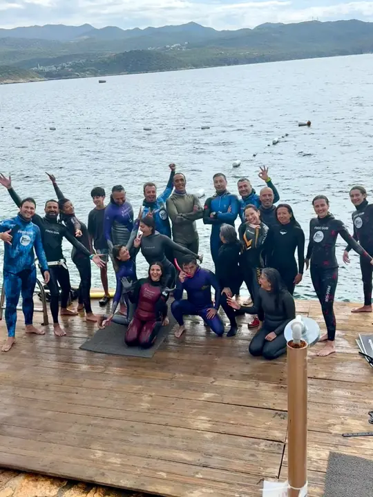 Freedivers in wetsuits on the dock after training